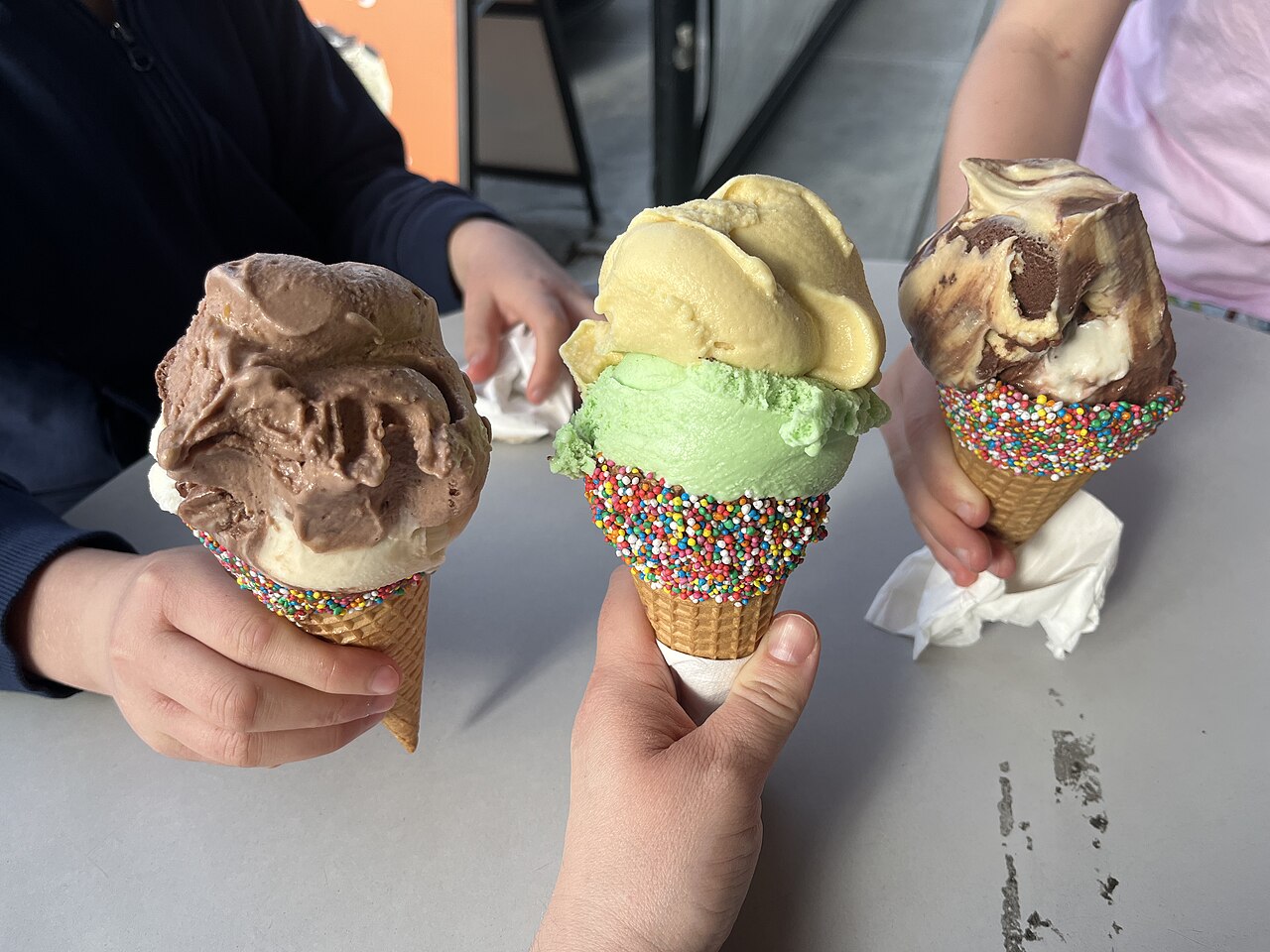 Assorted ice cream cones with berries and flowers